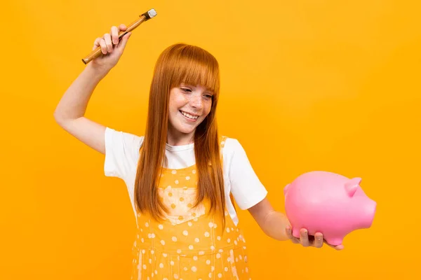 Cute Girl Piggy Bank Orange Background — Stock fotografie