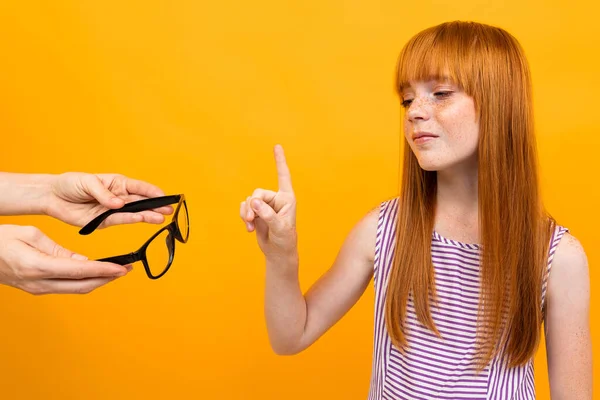 girl with bad vision against orange background