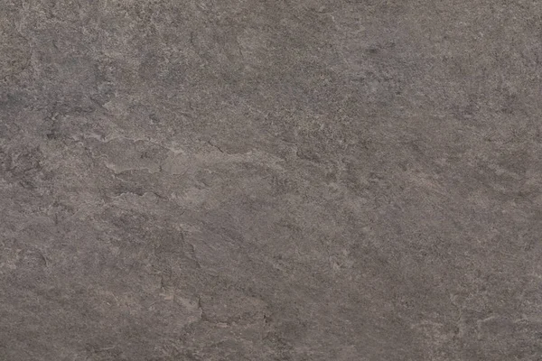 Bu yakın çekim bir taş yüzeyin karmaşık dokusunu yakalar, doğal renkler ve desenler gösterir. Taş, engebeli güzelliğini vurgulayan küçük çatlaklar ve pürüzlü bir his barındırıyor..