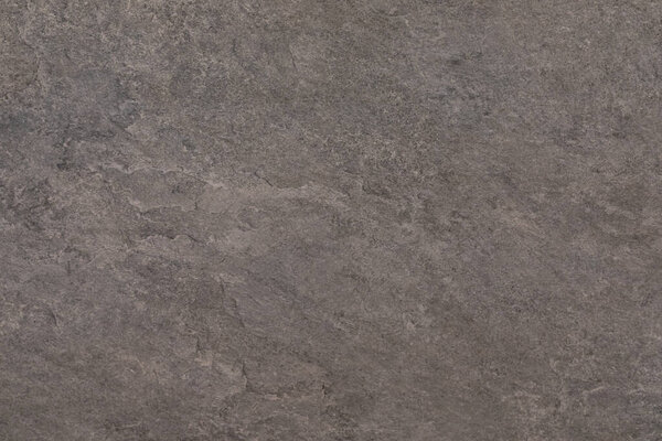 Этот вид крупным планом захватывает сложную текстуру каменной поверхности, демонстрируя естественные цвета и узоры. Камень имеет небольшие трещины и грубое чувство, подчеркивая свою прочную красоту.