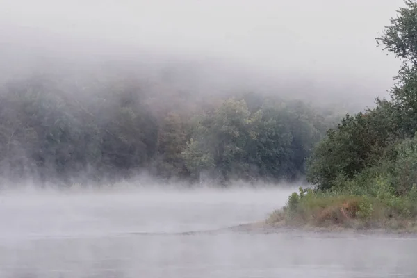Shawnee on Delaware, Pennsylvania: Early morning mist rising from waters of the Delaware River, in the Delaware Water Gap.