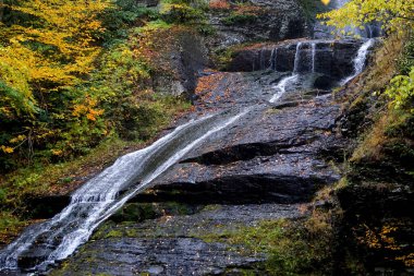 Delaware Township, Pike County, Pennsylvania: Autumn foliage surrounds Dingmans Falls, in the Delaware Water Gap National Recreation Area. clipart