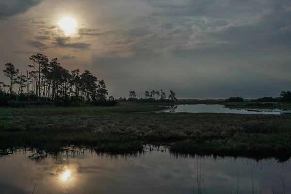 Chincoteague Adası, Virginia, ABD: Chincoteague Ulusal Vahşi Yaşam Sığınağı 'ndaki Kara Ördek Havuzu' nda gün doğumu.