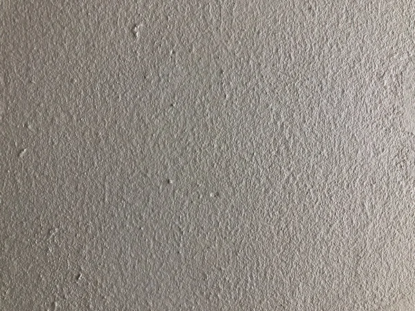 Gri çimento arka plan duvarının çimento alçısından yapılmış bir deseni var..