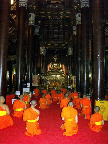 Chiang Mai, Thailand, April 24, 2016: Young Buddhist monks praying in a temple in Chiang Mai, Thailand.