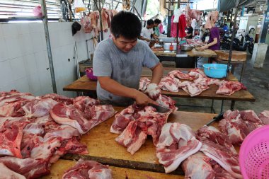 Georgetown, Penang, Malezya, 4 Ocak 2020: Bir adam Georgetown, Malezya 'daki Pasar Lebuh Cecil Market' te et kesiyor.