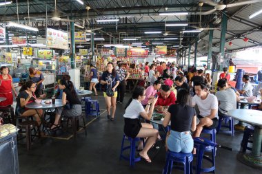 Georgetown, Penang, Malezya, 4 Ocak 2020: Georgetown, Malezya 'daki Pasar Lebuh Cecil Market' in masalarında birçok insan yemek yiyor.