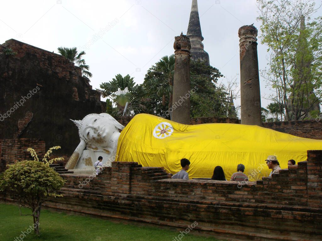 Ayutthaya, Thailand, January 24, 2013: Reclining Buddha covered with a golden cloth in Ayutthaya, former capital of the kingdom of Siam. Thailand