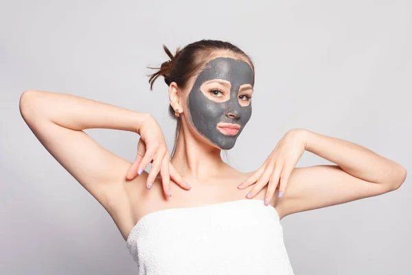 Woman Face Mask. Portrait Of Beautiful Girl Removing Cosmetic Black Peeling Mask From Facial Skin. Closeup Of Attractive Young Woman With Natural Makeup And Cosmetic Peel Mask On Face. High Resolution