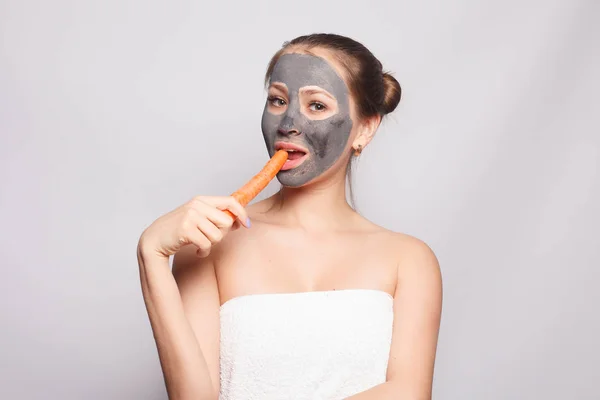 Woman Face Mask. Portrait Of Beautiful Girl Removing Cosmetic Black Peeling Mask From Facial Skin. Closeup Of Attractive Young Woman With Natural Makeup And Cosmetic Peel Mask On Face. High Resolution