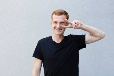 Moda, stil, duygular ve insanlar kavramı - Kızıl çilli bir gri ile güzel bir erkekçe adamın portresi yakından arka plan siyah T-shirt.