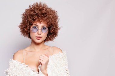 Gülümseyen genç siyah kadın portresi. Afro-Amerikan afro saç kesimi ve sihir makyaj ile güzel bir genç kadın portresi. Stüdyo vurdu. Çekici kız gözlük takıyor.