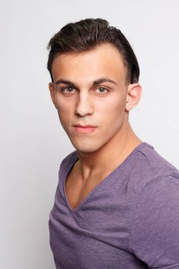 duygu, reklam ve insanlar kavramı - yakışıklı genç adam kameraya bakarak gri arka plan üzerinde. Seksi bir adam portresi. Mutlu erkek gülümseyen.