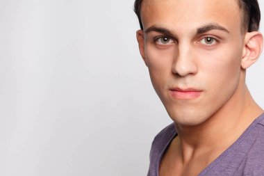 duygu, reklam ve insanlar kavramı - yakışıklı genç adam kameraya bakarak gri arka plan üzerinde. Seksi bir adam portresi. Mutlu erkek gülümseyen.