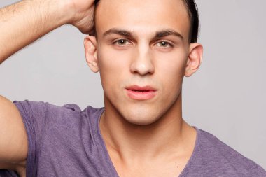 duygu, reklam ve insanlar kavramı - yakışıklı genç adam kameraya bakarak gri arka plan üzerinde. Seksi bir adam portresi. Mutlu erkek gülümseyen.