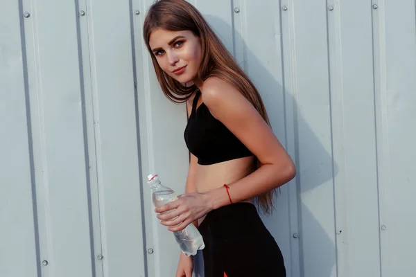 Female Athlete Drinking Water While Standing Grey Wall Slim Woman — Stock Photo, Image