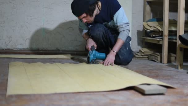Profession, people, carpentry, emotion and people concept -A carpenter cuts a board with an electric jigsaw. manufacture of skateboards. he has protective clothing and mask. 4k — Stock Footage Profession People Carpentry Emotion People Concept Carpenter Cuts Board Electric Stock Footage