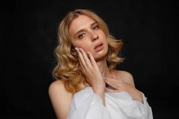 Beautiful young transgender with blond hair, dark blue background — Stock Photo, Image