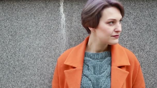 초상화 매력적인 카메라 카메라 느끼고 슬로우 도시에서 오렌지 코트에 여자의 — 비디오