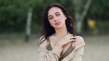 Mutlu beyaz kız gün batımında kumsalın keyfini çıkarıyor. Bikinili gülümseyen kız. Gün batımı maneviyatı keşfediyor. Seyahat etmeyi düşünüyor. Dışarıda dinleniyor.