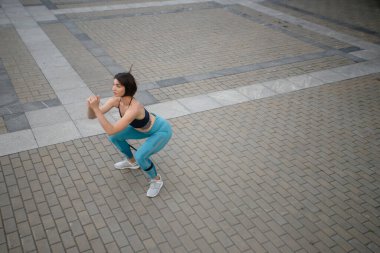 Bir sporcunun duvar kenarında esneme egzersizi yapması. Spor salonundaki kadın duvar kenarında egzersiz yapıyor. Boş zaman, boş zaman, boş zaman.