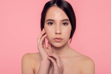 Confident young woman with glowing skin, symbol of self care and healthy living.