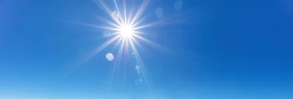 Fondo del cielo con rayos de sol en el cielo azul brillante —  Fotos de Stock