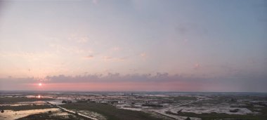 Bulutlu, güzel, yumuşak şafak veya gün batımı, yatay fotoğraf 16: 9, havadan fotoğraflar, alçak güneş ışınları bulutları delip geçiyor