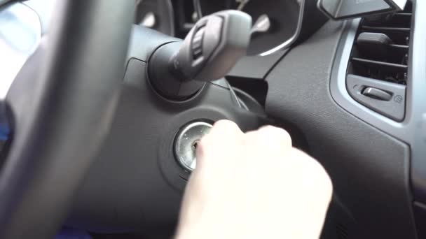 Close up of girl putting key into key whole for making car starts to work. She turns it to the right. — Stock Video