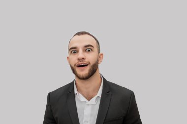 Heyecanlı ve baktılar genç adam düz bakmak ve merak ediyorum. O ağız açık tutun. Adam giyim takım. Beyaz arka plan üzerinde izole.