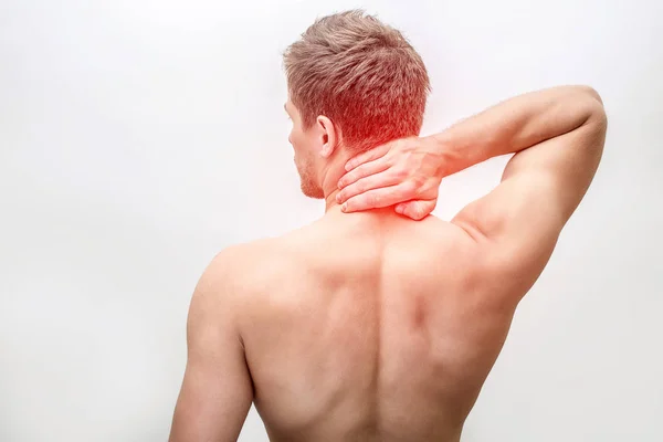 Red spot on young mans neck. He hold hand there. Guy shows shirtless back. Isolated on white background. — Stock Photo, Image