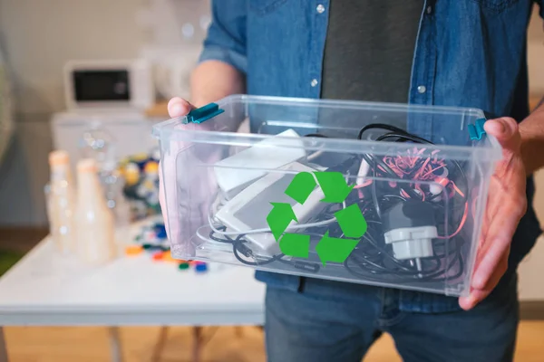 Recycling concept. An electronic waste in recycling contaner close-up. Responsible man is protecting environment while sorting the waste at home — Stock Photo, Image