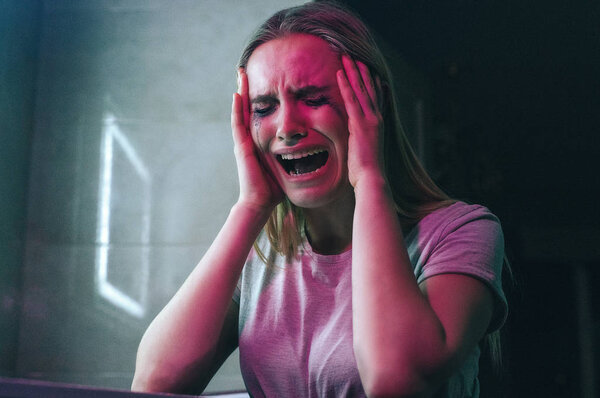 Fight with drug addition. Drug addict holds hands on her hand and is going crazy near drugs. Drug addicted woman with smeared makeup screaming in night clubs toilet. Drug kill you. Drug obsession and