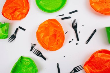 Plastik ücretsiz olun. Beyaz bir arka planda tek kullanımlık renkli kırık plastik plakalar ve çatal. Plastik kirliliği durdurun. Azaltın, yeniden, geri dönüşüm. AB Direktifi ile ilgili bir sorun. Üst görünüm