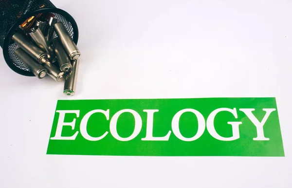 Recycling, reuse, reduce concept. Recycling electric waste. Paper with word Ecology near batteries in the metal box on white background. Save ecology. Top view — Stock Photo, Image