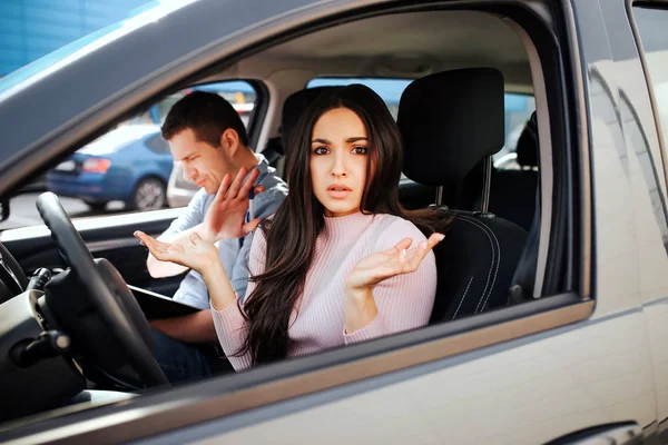 Male auto instructor takes exam in young woman. Confused stressed model look on camera. Instructor examining girl. Sit together in car. — Stock Photo, Image