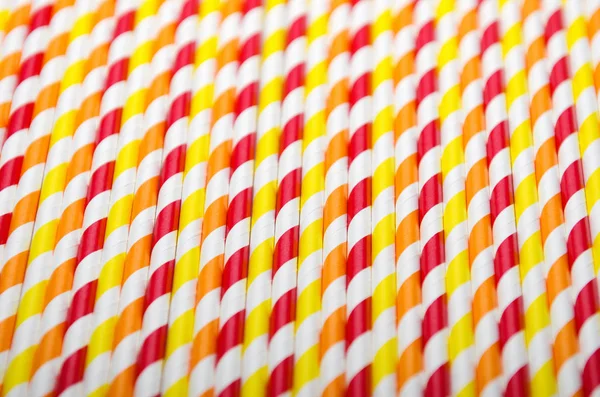 Colorful juice straw in row on white background. Close up