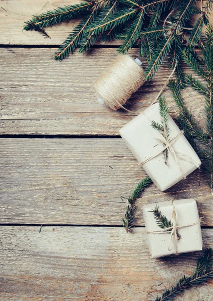 Cajas de regalo con ramas de abeto sobre fondo de madera. Estilo rústico. Concepto de preparación para el nuevo año. espacio de copia. Tonelada foto . — Foto de Stock