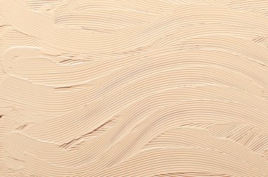 Çıplak yüz kremi dokuyu kapatır. Doğal kozmetik bej boya lekesi. Kadın yüz makyajı, renkli kremli kozmetoloji prosedürü. Fırça darbeleriyle soyut arkaplan