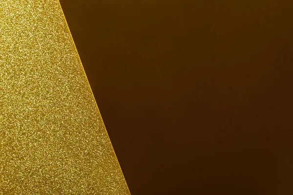 Gold glitter close up background. Sparkling yellow backdrop with metallic surface. Glamorous golden sand grains, luxurious shimmering sequin texture. Fashionable glowing shiny sparkles.