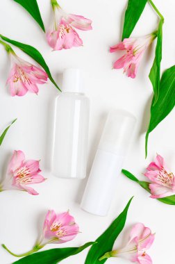 Micellar su, makyaj çıkarıcı şeffaf şişe maketi. Doğal kozmetoloji sıvısı, çiçek arka planında organik kozmetik. Nemlendirici losyon. Kadınların cilt bakım ürünleri