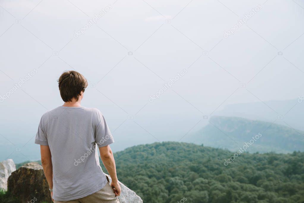 young man contemplating summer landscape 