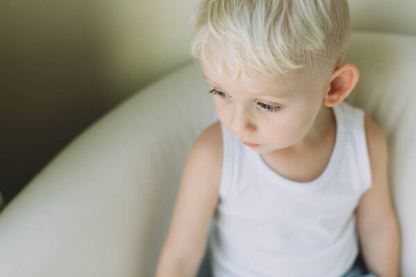 Portrait of adorable little boy sitting on a sofa