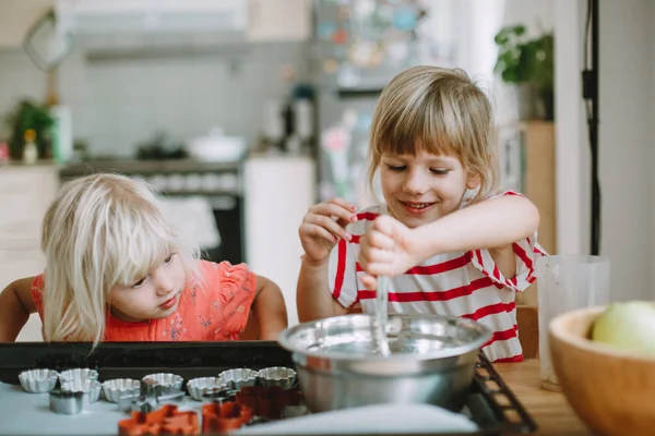 Two cute little sisters cooking at home — Stock Image Two Cute Little Sisters Cooking Home Royalty Free Stock Photos