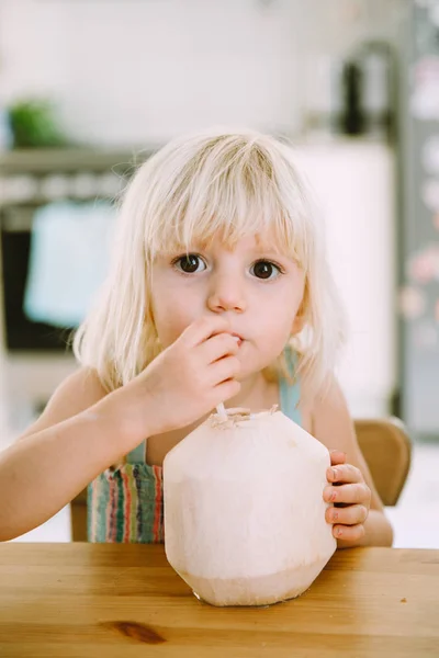 Прелестная Маленькая Девочка Пьет Кокосовое Молоко Дома — стоковое фото