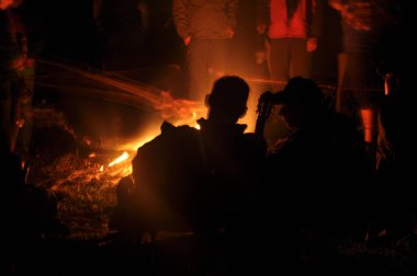 Stare Jablonki, Warminsko - Mazurskie Voyvodeship / Polonya - 05.14.2016: Geceleri şenlik ateşiyle konuşan iki kişi.