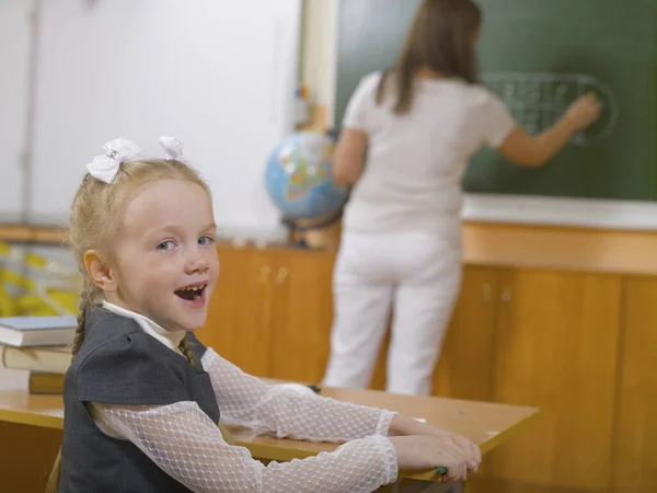 Little girl in school class at the lesson