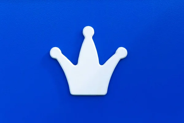 .Bílá koruna na modrém pozadí. Prvek výzdoby, symbol moci, bohatství. Hlavu panovníka. Šachový král.. — Stock fotografie