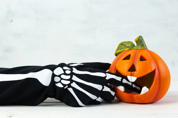 Orange Decorative Cheerful Pumpkin Lantern Bites Hand Skeleton White Background — Stock Photo, Image