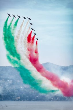 The Italian Aerobatic Display Team the Frecce Tricolori formation flying over the Lake Maggiore, Verbania, Italy clipart